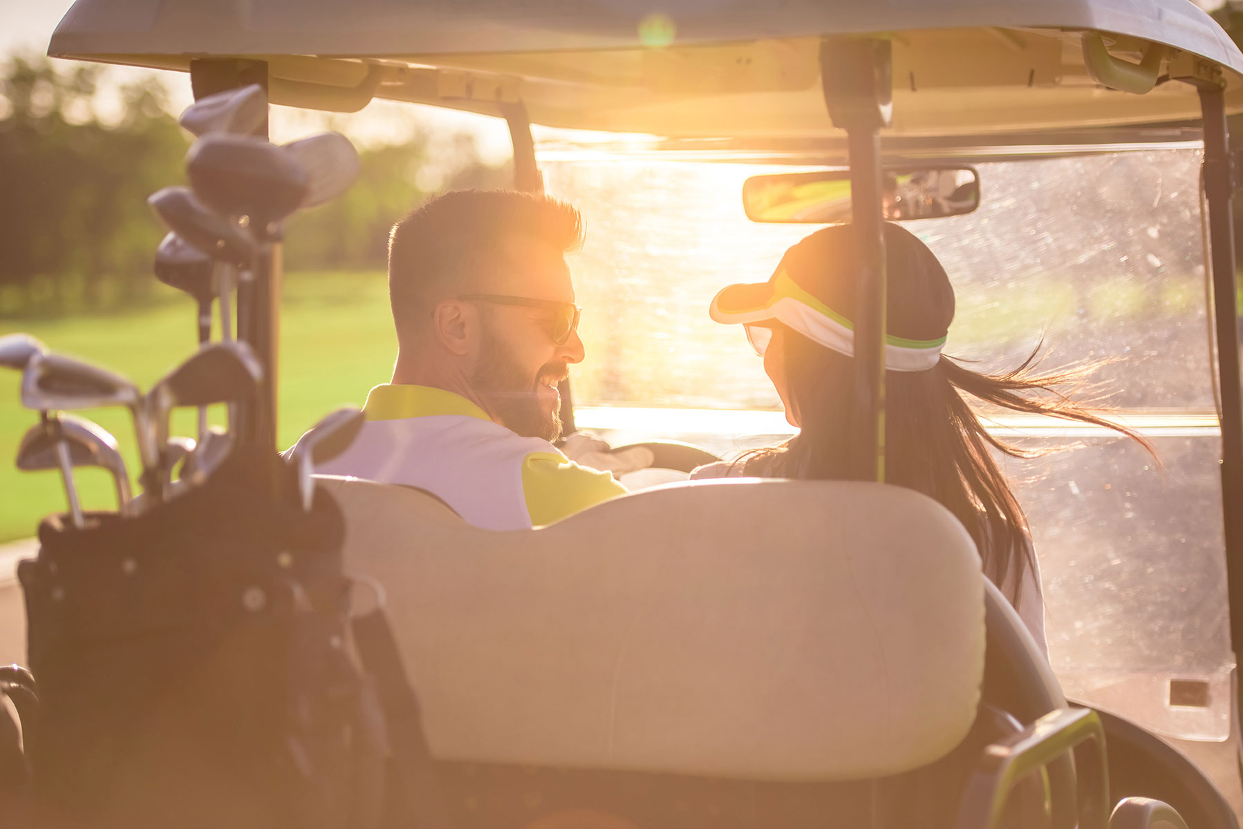 Couple in a golf cart playing a game of golf